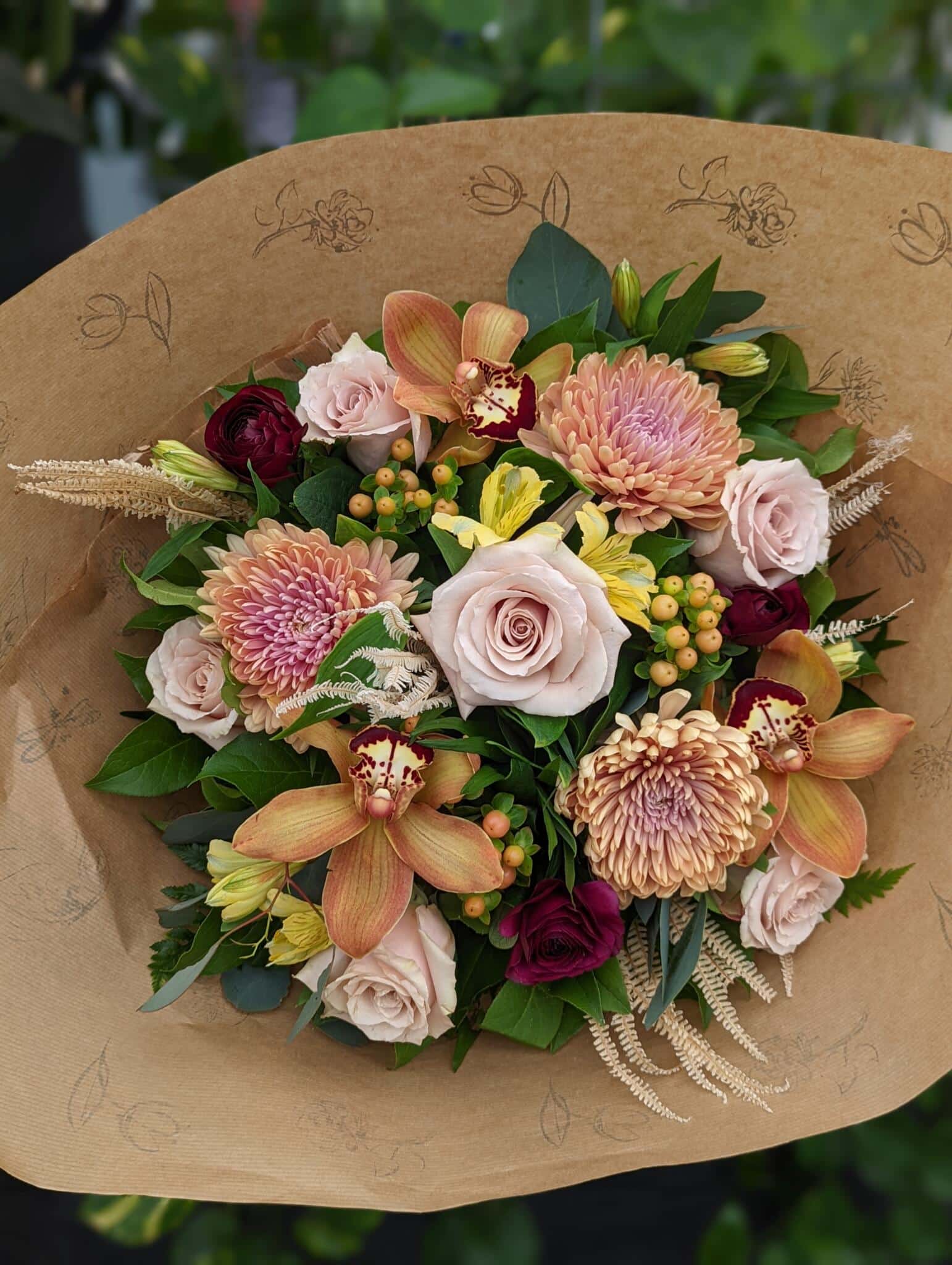 The Watering Can | A warm blush, yellow, and burgundy hand-tied bouquet.
