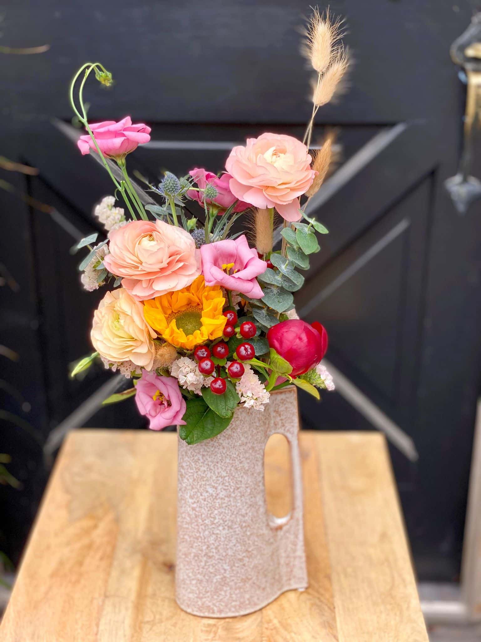 The Watering Can | A summery wild flower bouquet in a ceramic watering can shaped vase.