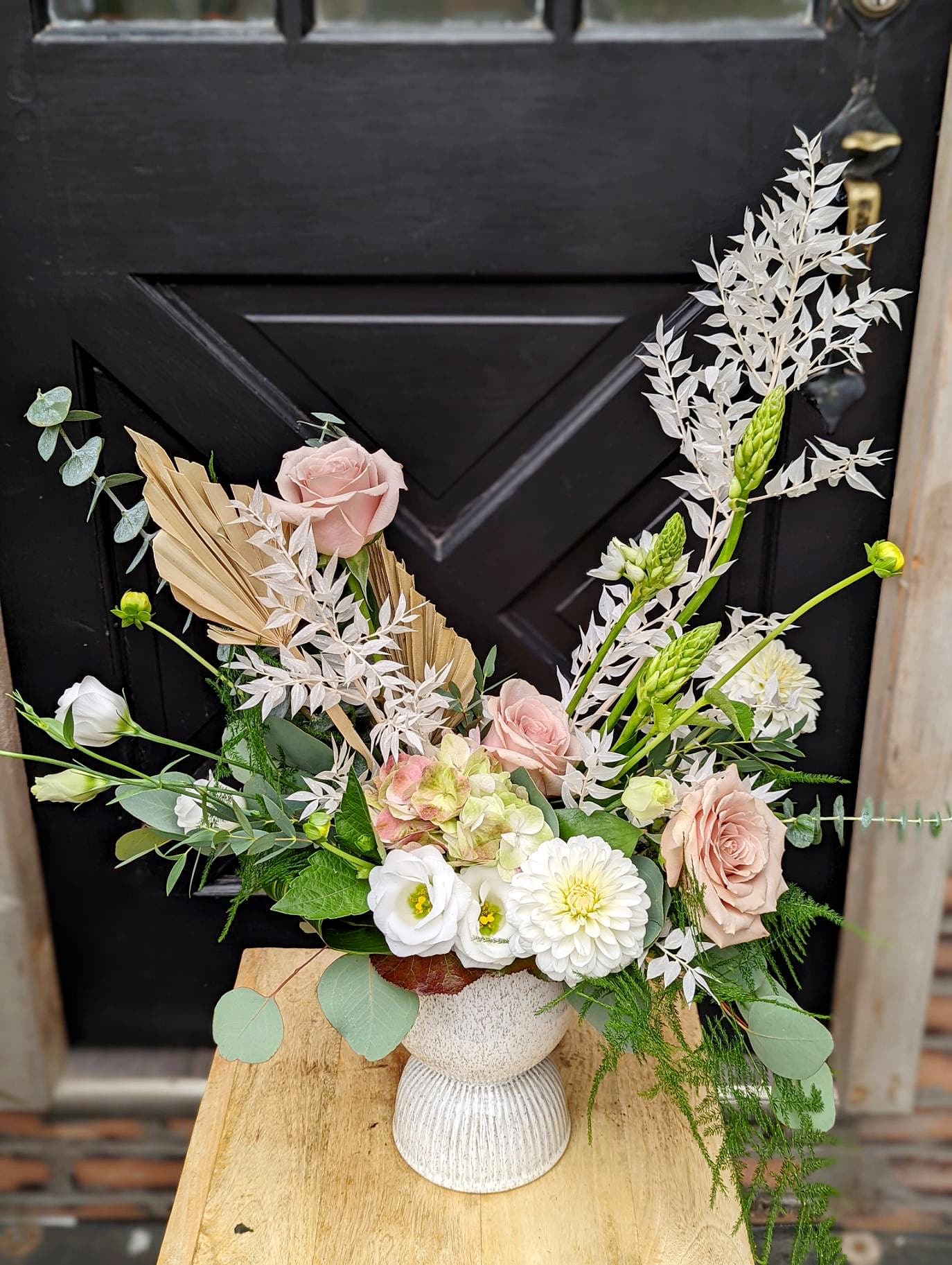 The Watering Can | An airy and elegant white and blush European style floral arrangement in a white ceramic container.