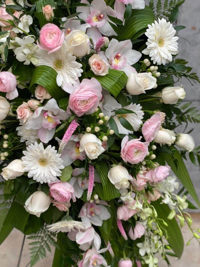 The Watering Can | Close up of the blush pink and white flowers used in an easel spray.