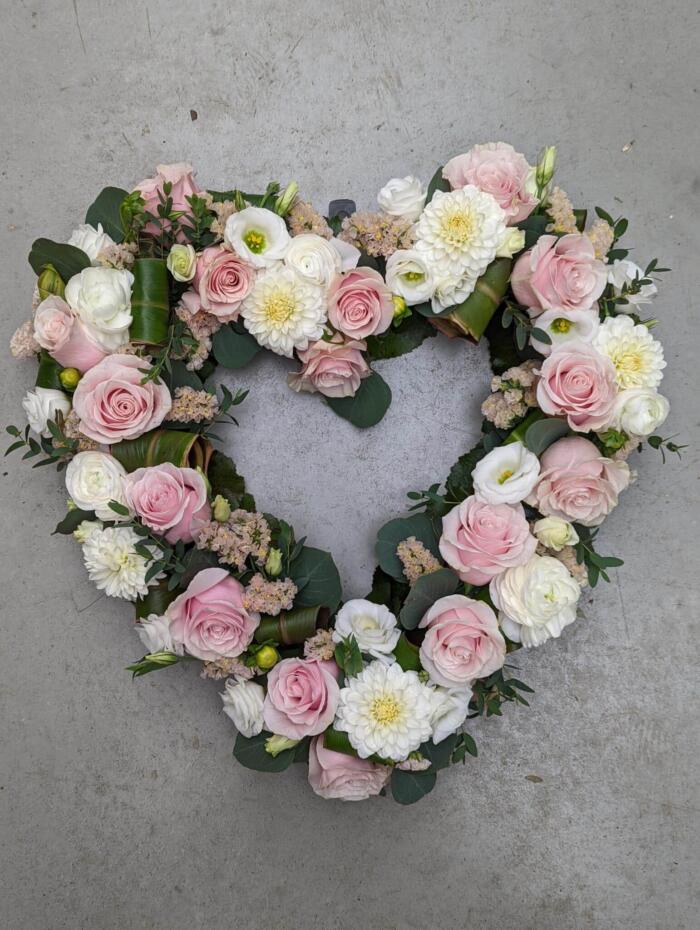 The Watering Can | An open pink and white heart filled with roses, dahlias, lisianthus, rununculus, and statice.