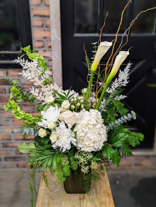 The Watering Can | An all white bouquet in a rectangular, textured glass vase.